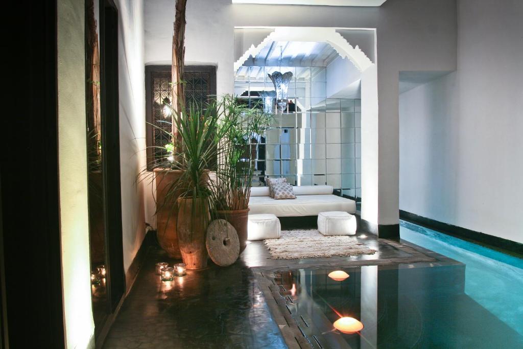 a living room with a swimming pool and a house at Riad Golfame in Marrakesh