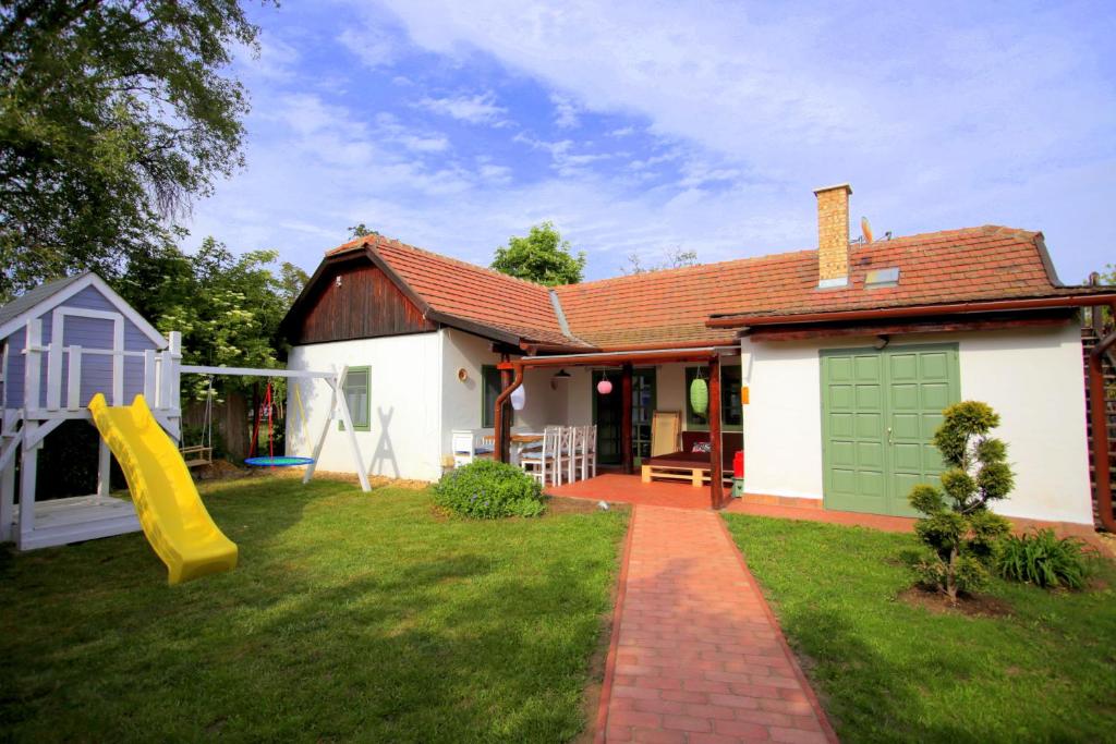 una casa con un patio con un tobogán en Fekete Gólya XL, en Tiszafüred