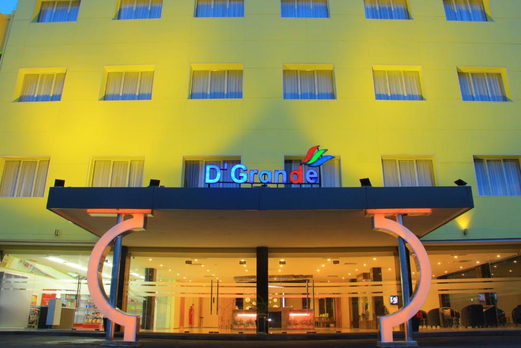a building with a sign on the front of it at D'Grande Hotel Batam in Nagoya