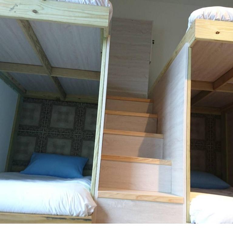 Postel nebo postele na pokoji v ubytování 馬公港精品旅宿包棟烤肉附設租車
