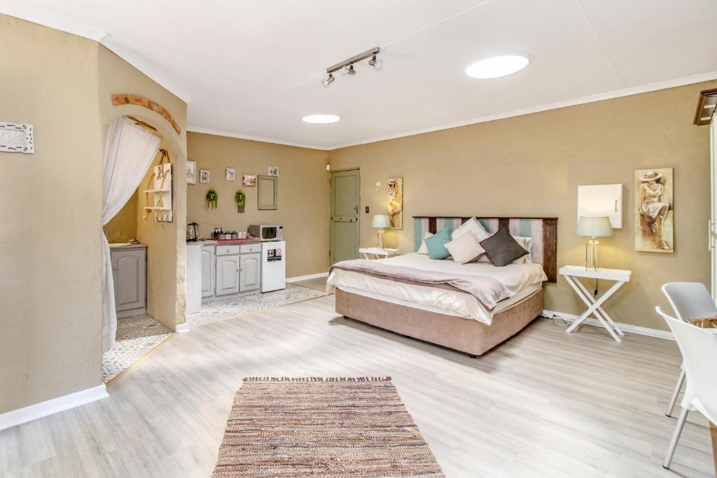 una grande camera da letto con letto e cucina di Villa Roma - Luxury Accommodation a Centurion