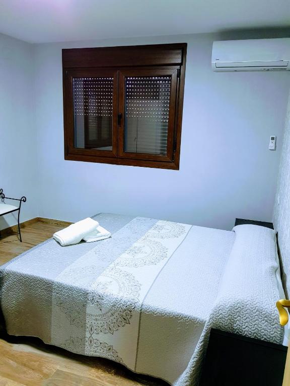 Postel nebo postele na pokoji v ubytování APARTAMENTOS LOS ÁLAMOS