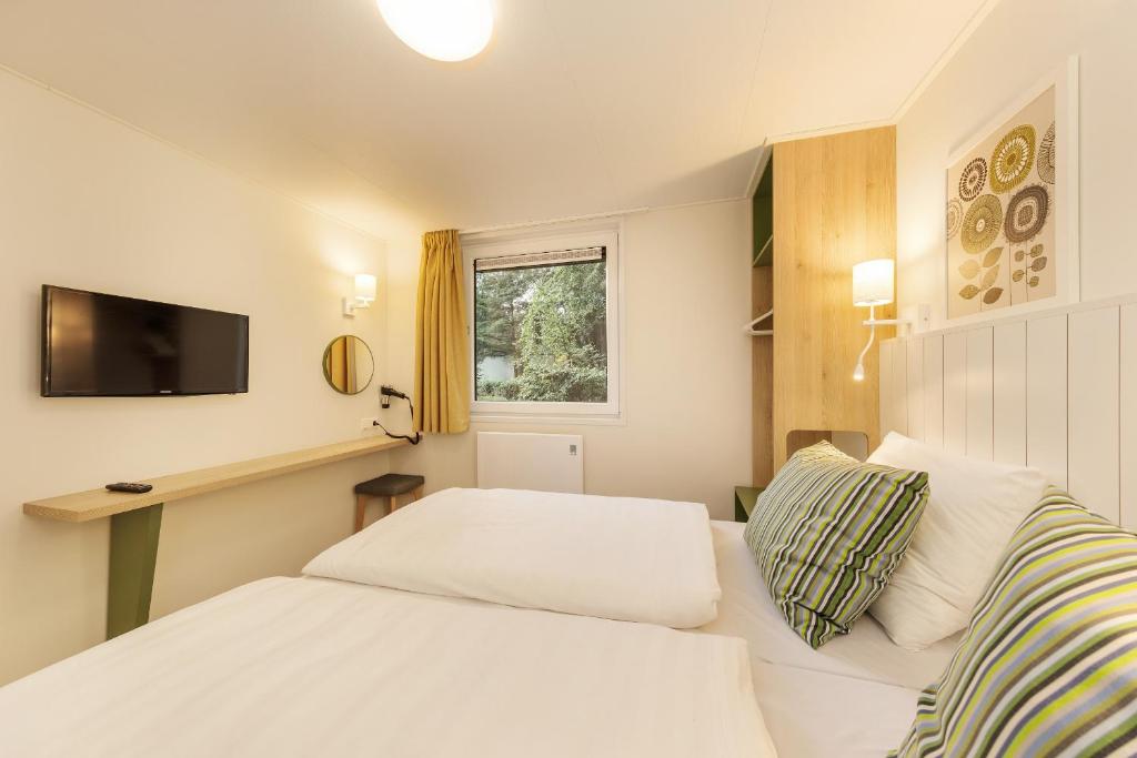 Postel nebo postele na pokoji v ubytování Center Parcs De Eemhof