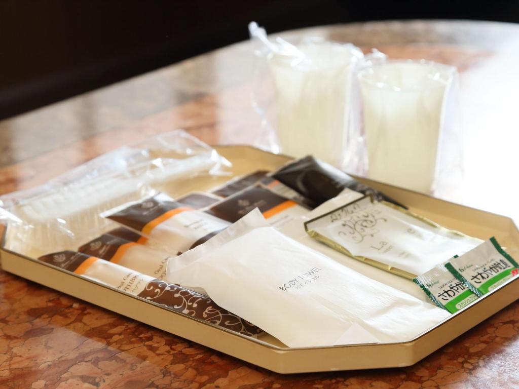 a tray of food on a table with milk at Hotel Fine Garden Suzuka in Suzuka