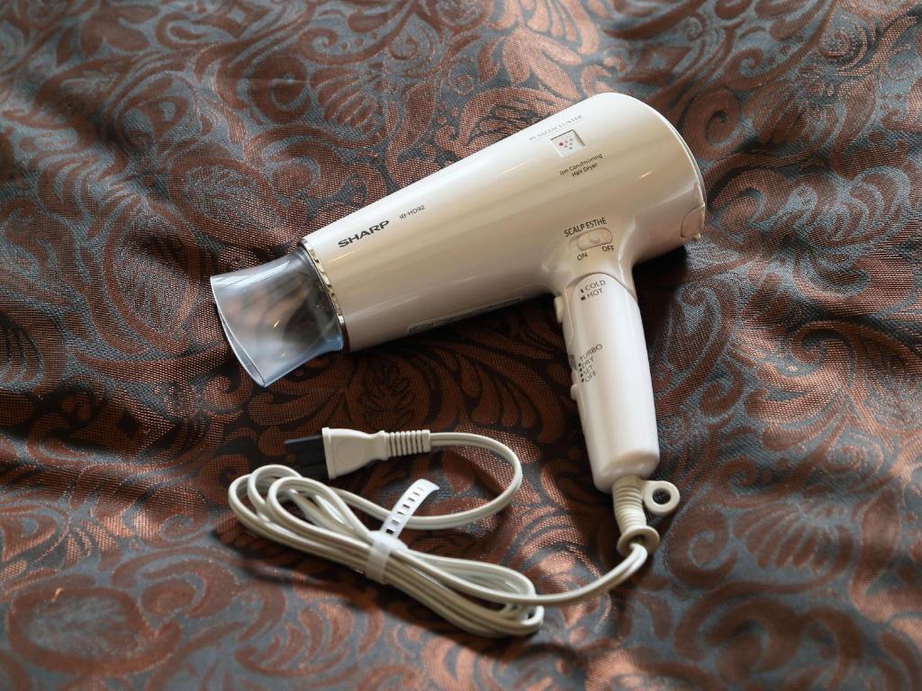 a hair dryer with a cord on a table at Hotel Fine Garden Suzuka in Suzuka