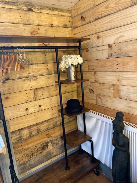 a hat on a shelf in a room with wooden walls at Willow Court Farm Studio East & Petting Farm, 8 mins to Legoland & Windsor, 15 mins to Lapland UK in Windsor