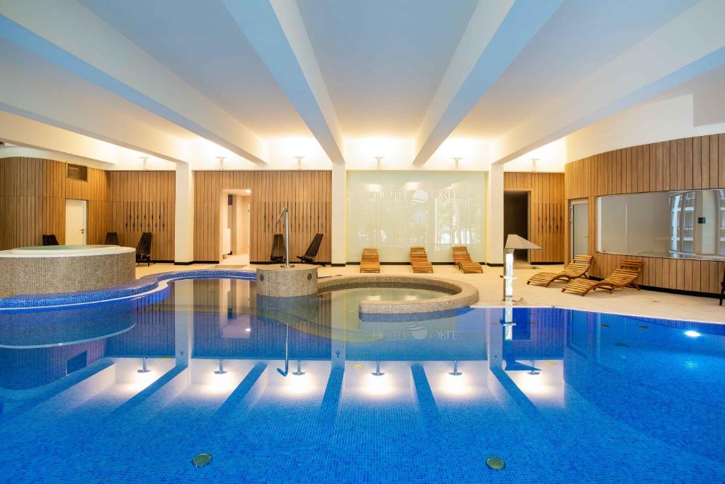 a large swimming pool in a hotel room at Hotel Orle in Gdańsk