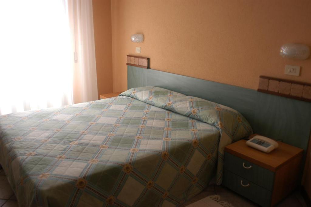 Postel nebo postele na pokoji v ubytování Hotel Maré - Valentini Family Village