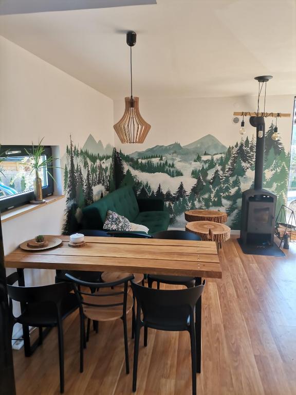 a living room with a table and a couch at Bieszczadzkie BOHO stodoły z jacuzzi i sauna na wyłączność in Myczkowce
