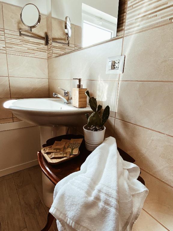 a bathroom with a sink and a mirror at La casetta al maneggio in Catania