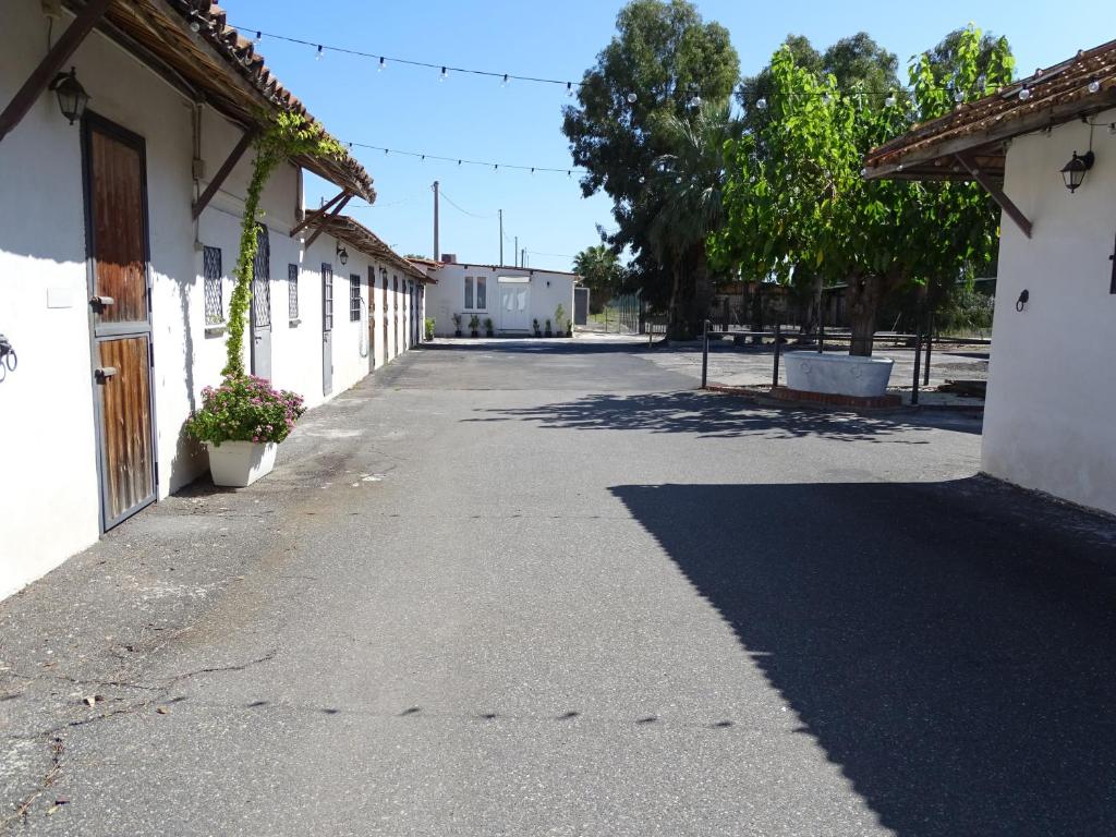 an empty street in front of a building at La casetta al maneggio in Catania
