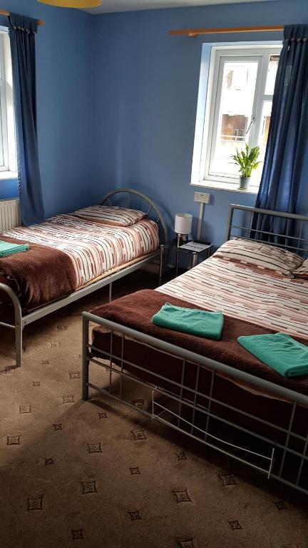 Postel nebo postele na pokoji v ubytování Hour Glass Hotel