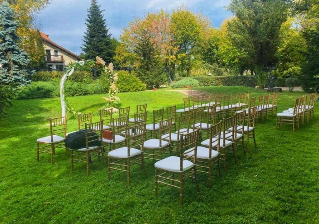a row of chairs sitting in the grass at Caro Hotel in Bucharest