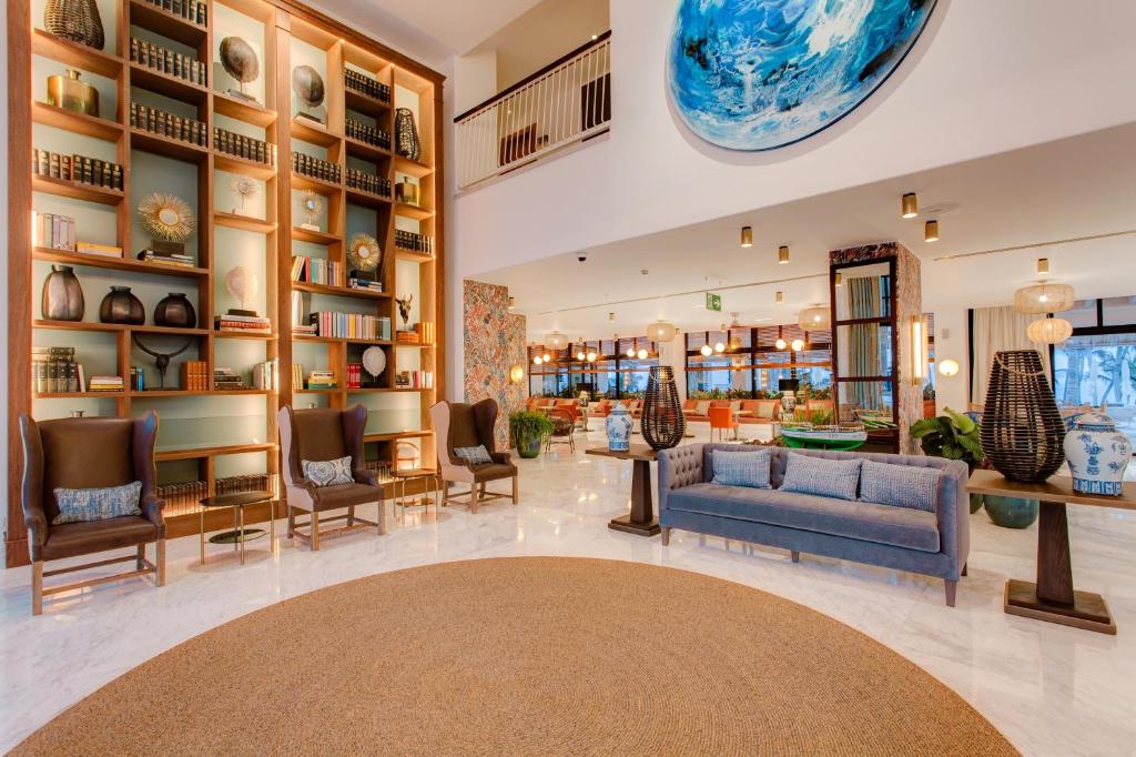 a lobby of a store with a blue couch and chairs at Hotel Fariones in Puerto del Carmen