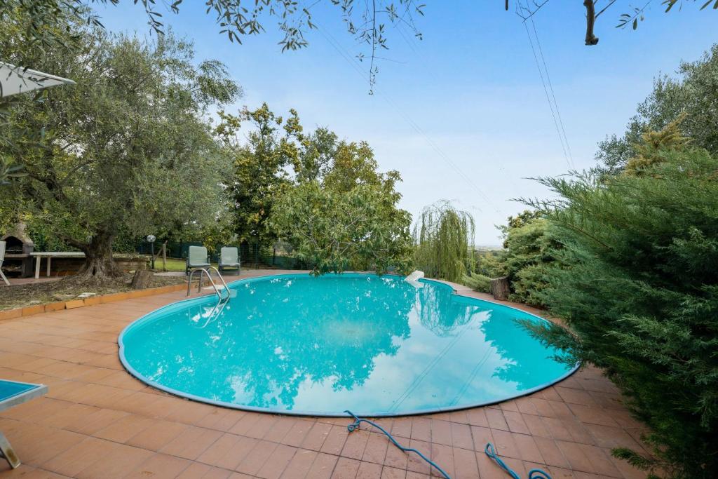 a swimming pool in a yard with trees at 3 bedrooms apartement with private pool jacuzzi and enclosed garden at Fabrica di Roma in Fabrica di Roma