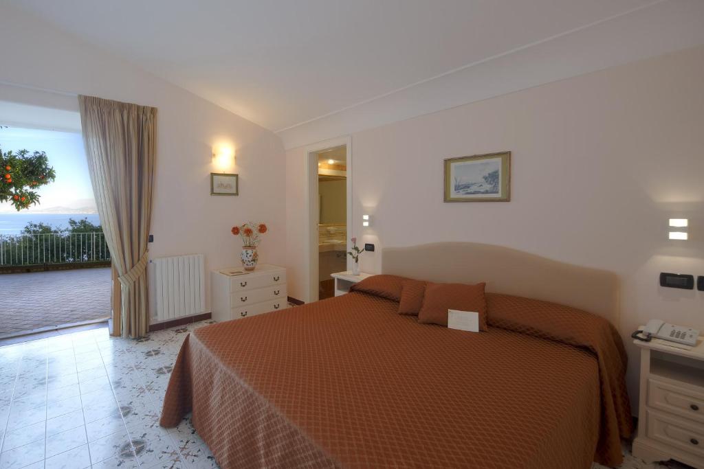 a bedroom with a bed and a balcony at Le Querce Resort Sea Thermae & Spa in Ischia