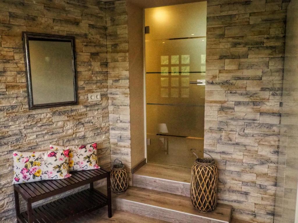 a bathroom with a bench in a stone wall at Dorfidylle - Thüringer Wald Rennsteig in Friedrichroda