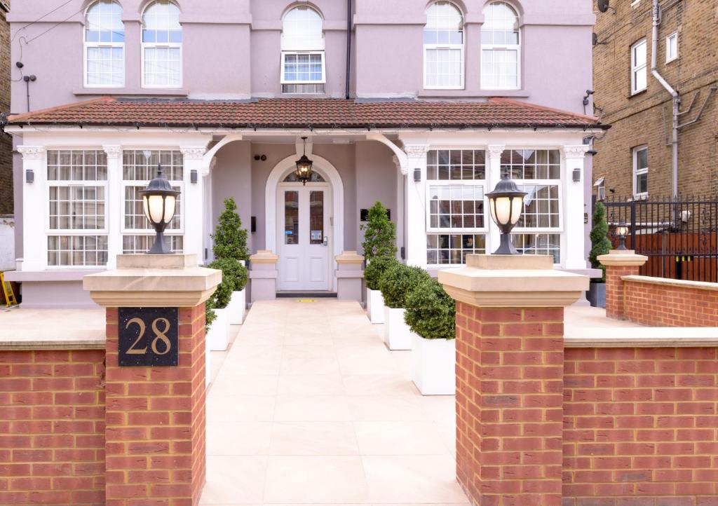 a house with a gate with the number on it at Imperial Guest House Ltd. in Hounslow