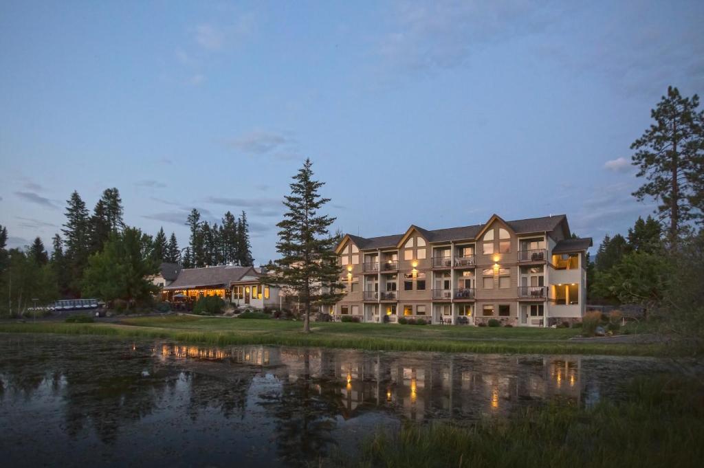 a large building next to a body of water at Meadow Lake Resort & Condos in Columbia Falls