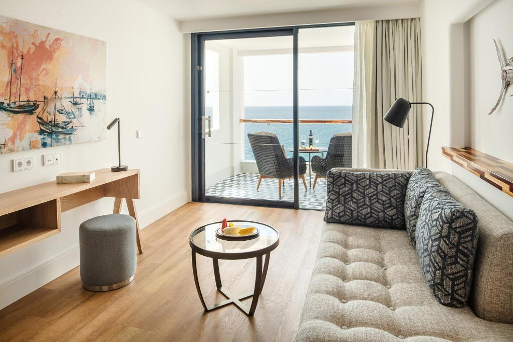 a living room with a couch and a table at Hotel Fariones in Puerto del Carmen