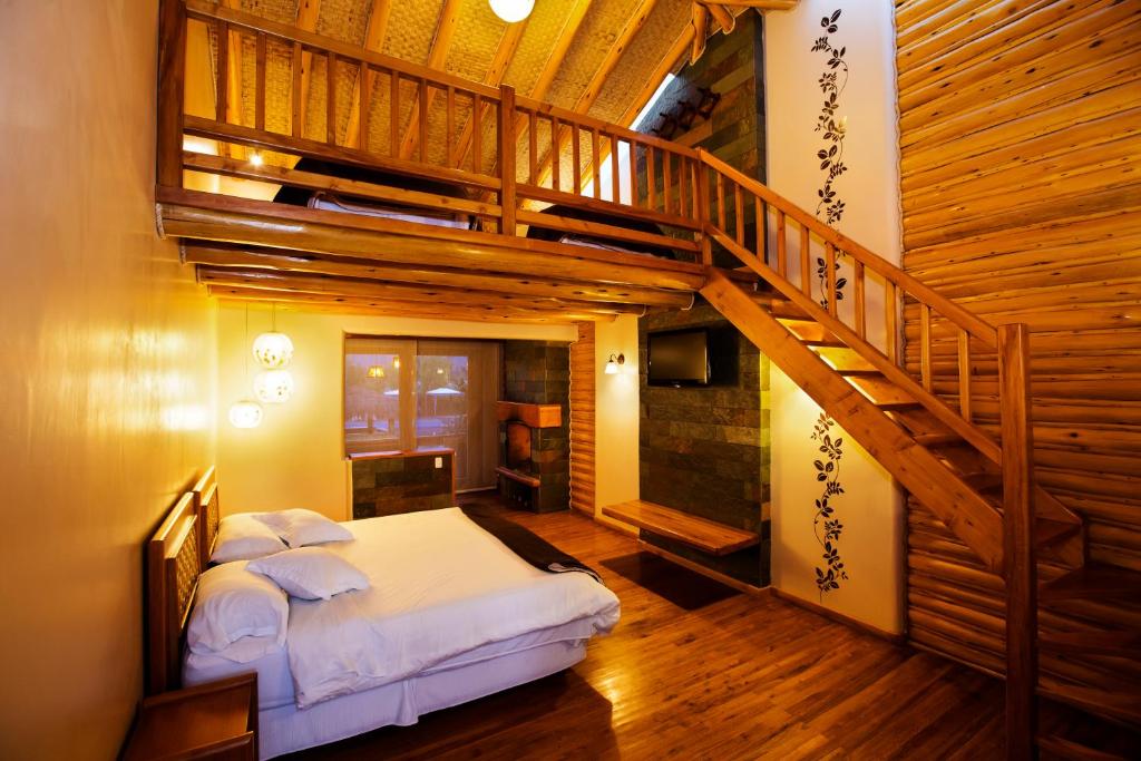 Postel nebo postele na pokoji v ubytování Hosteria Cabañas Del Lago