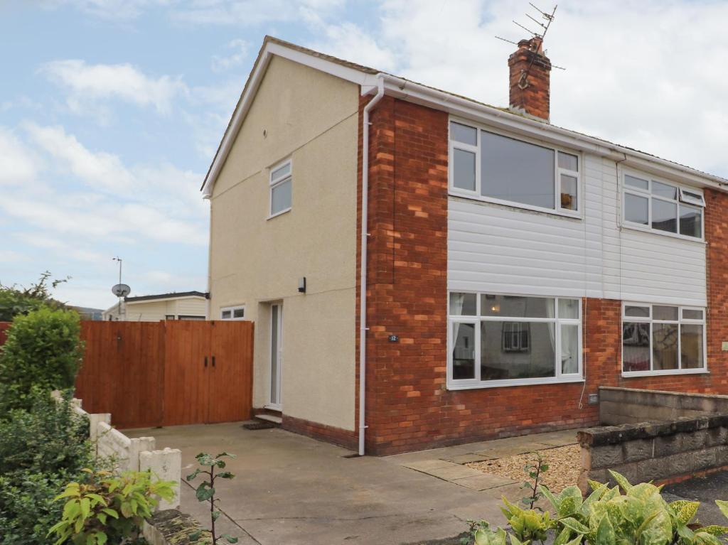 an image of a brick house with a garage at Ty Haf Summerhouse in Prestatyn