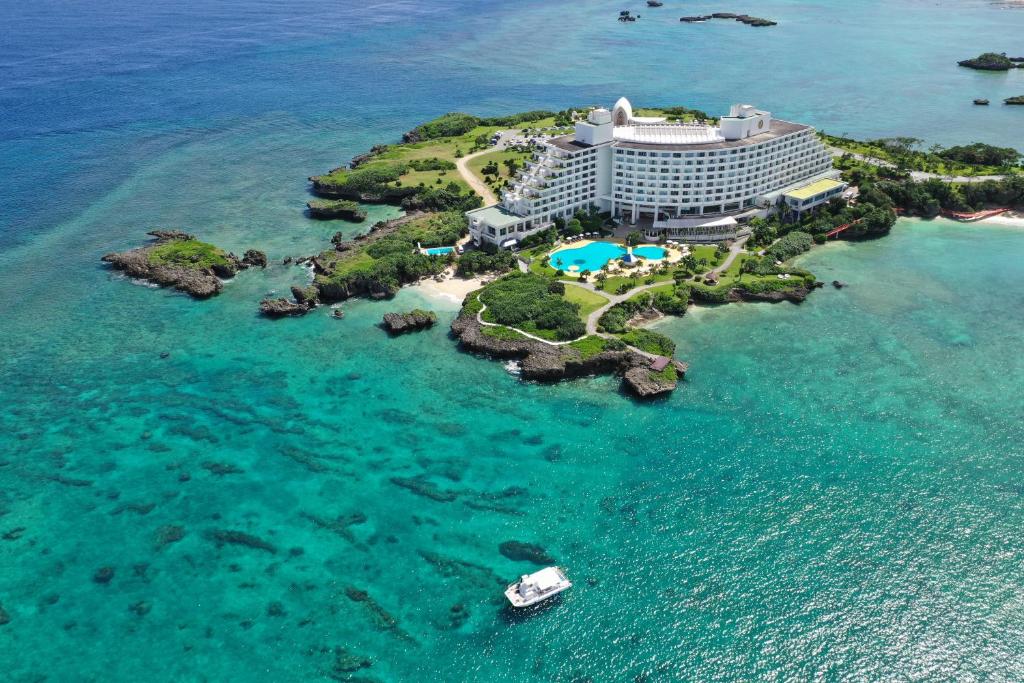an aerial view of a hotel on a island in the ocean at ANA InterContinental Manza Beach Resort by IHG in Onna