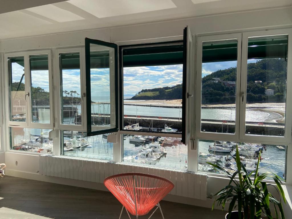 a room with a window with a view of a marina at Itsasoan Barrena in Lekeitio