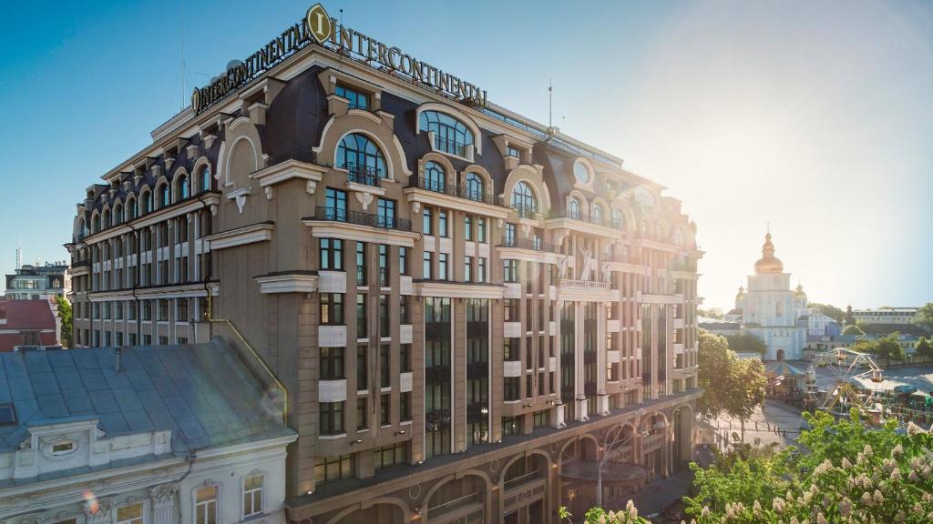 a large building with a clock on the side of it at InterContinental - Kyiv, an IHG Hotel in Kyiv