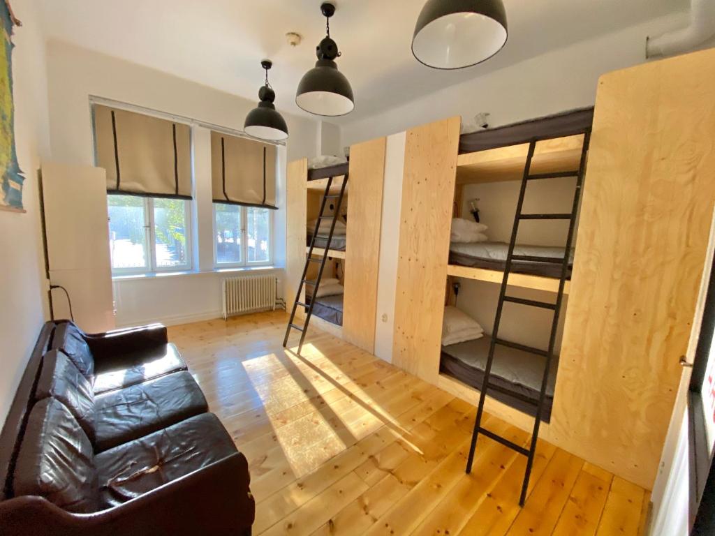 a living room with bunk beds and a couch at City Backpackers Hostel in Stockholm