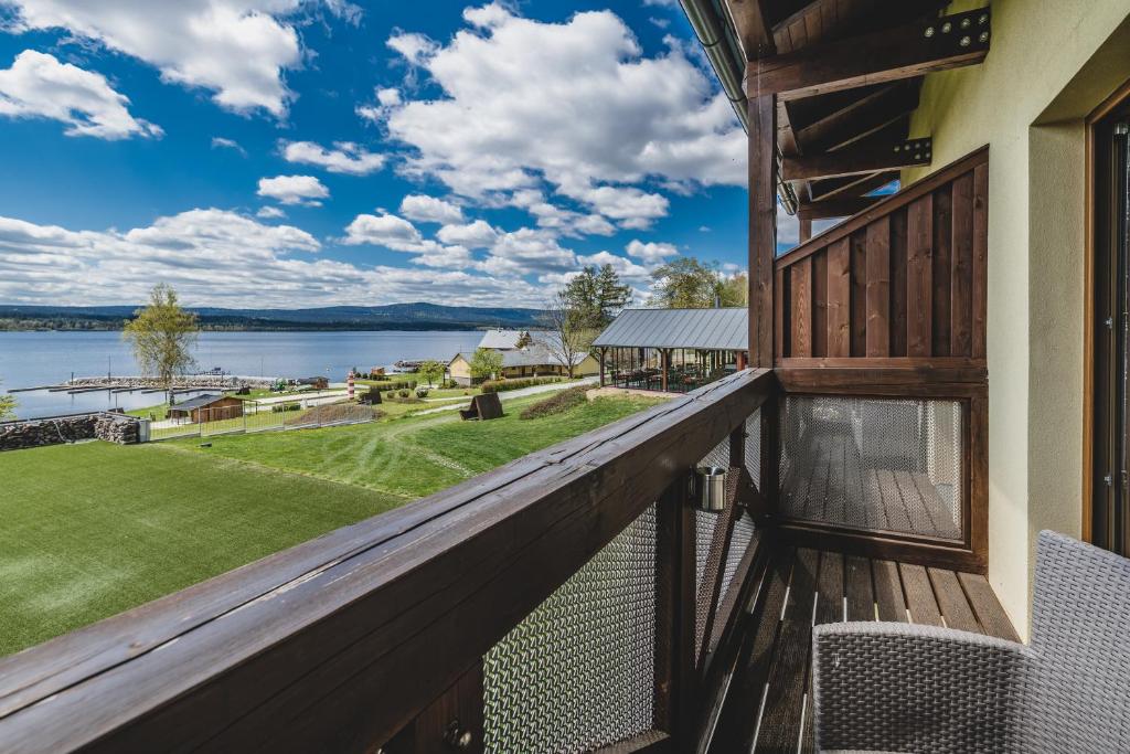 a balcony with a view of the water at Hotel Resort Relax in Dolní Vltavice