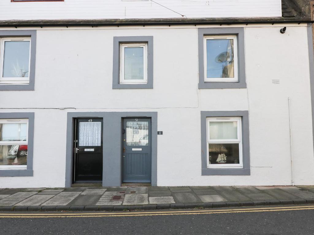 a white house with black doors and windows at Sea Spray in Eyemouth