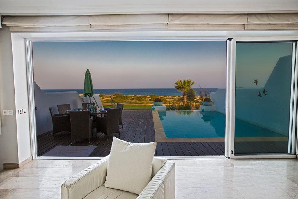 a living room with a view of the ocean at Villa Fig Tree Bay Seafront Luxury 5BDR Seafront Protaras Villa with Panoramic Sea Views in Protaras