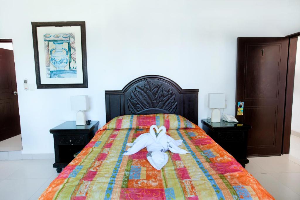 Postel nebo postele na pokoji v ubytování Hotel Del Sol