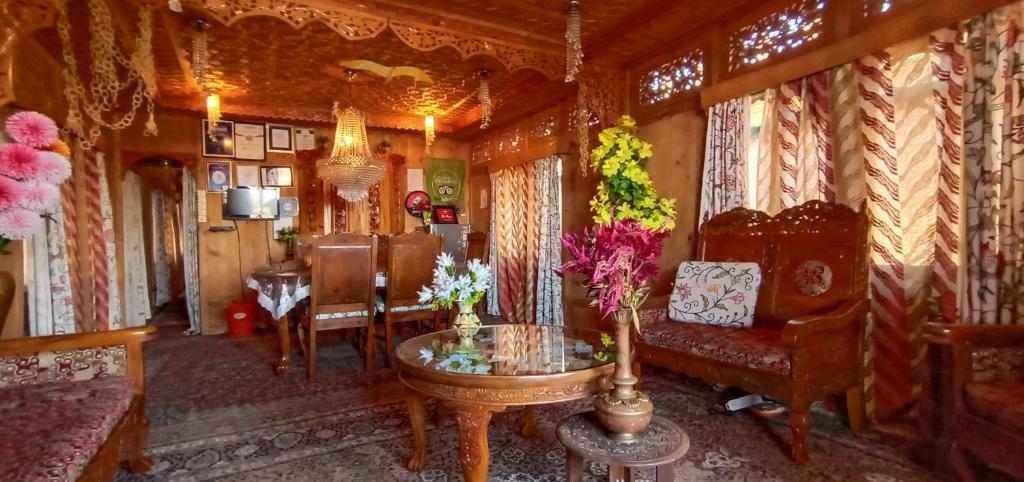 a living room with a couch and a table at Houseboat New Suzan in Srinagar