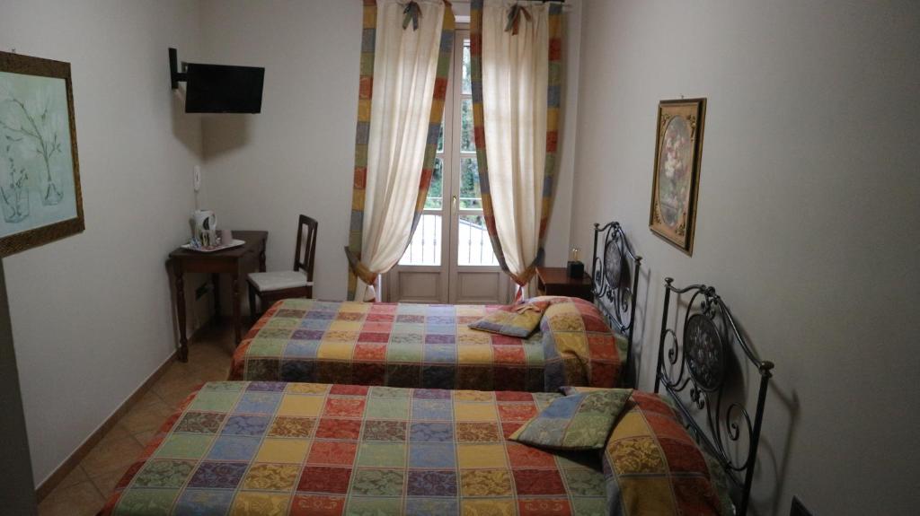 Postel nebo postele na pokoji v ubytování La Regibussa - Hotel Ristorante