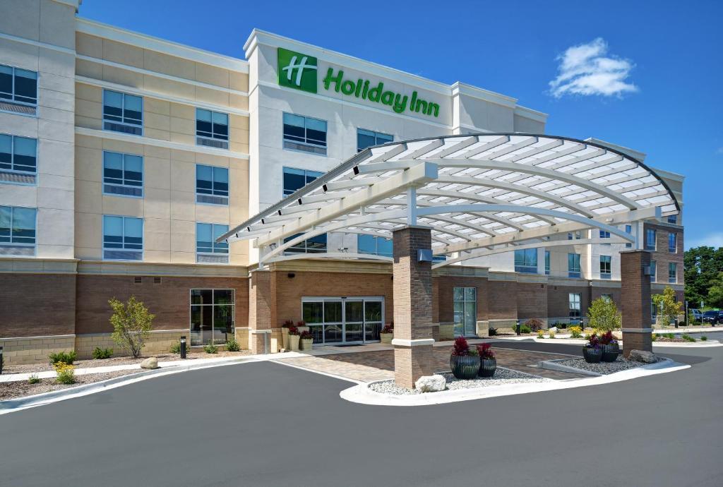 a hospital building with a healthcare sign in front of it at Holiday Inn Grand Rapids North - Walker, an IHG Hotel in Walker