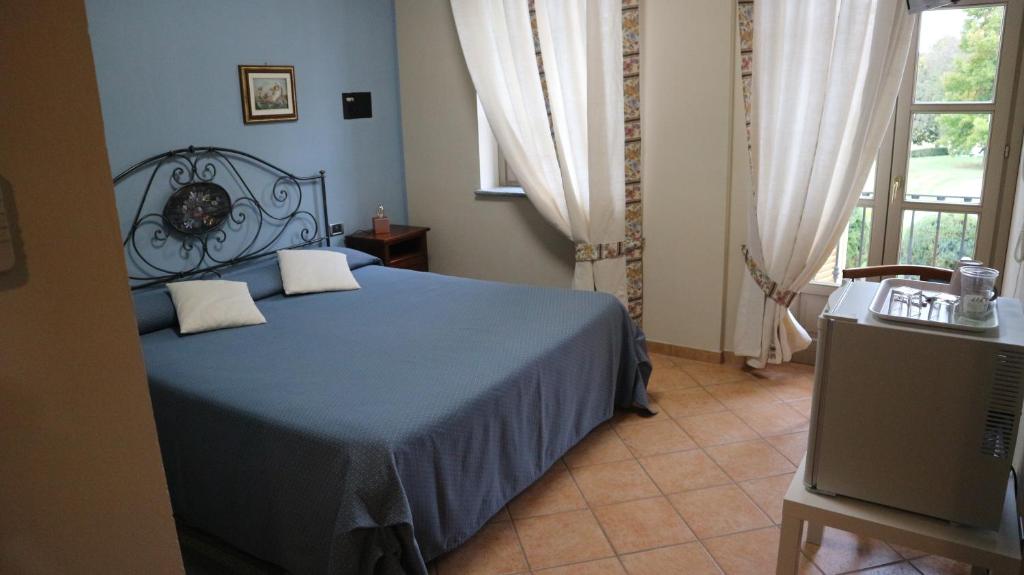 Postel nebo postele na pokoji v ubytování La Regibussa - Hotel Ristorante