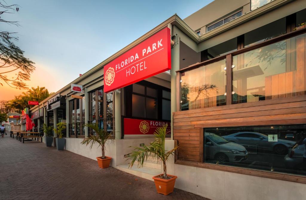 a building with a sign for a car dealership at Florida Park Hotel, Florida Road in Durban