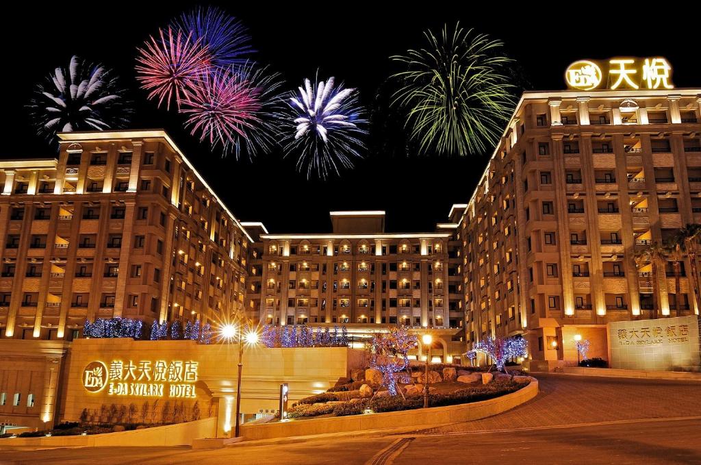 a building with fireworks exploding in the sky behind it at E-DA Skylark Hotel in Dashu
