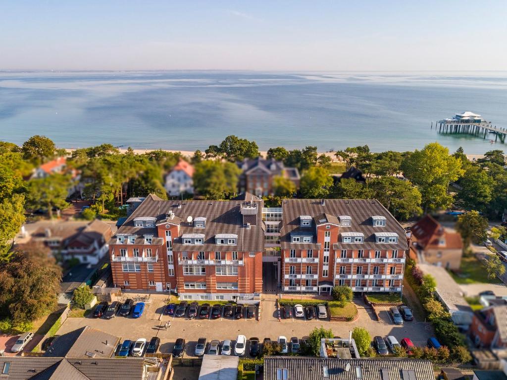 an aerial view of a building with the ocean in the background at Country Hotel Timmendorfer Strand in Timmendorfer Strand