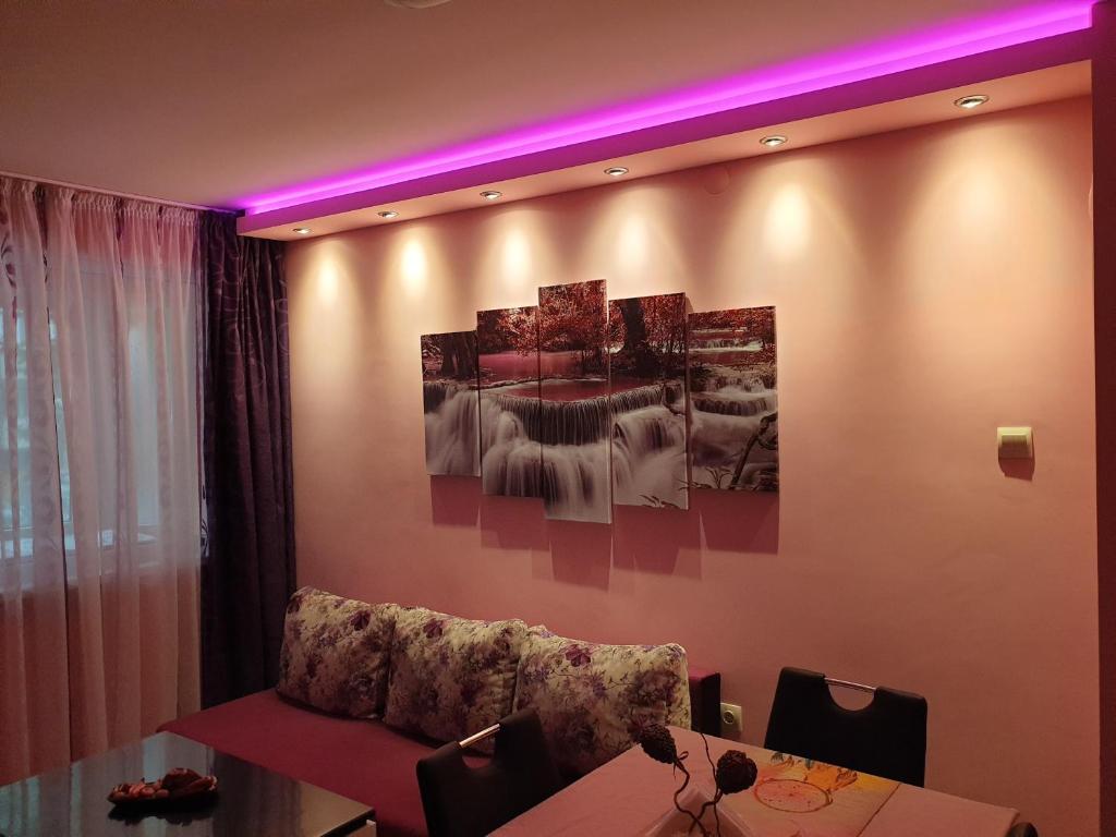 a dining room with a couch and a table at Apartment Nicole in Varna City