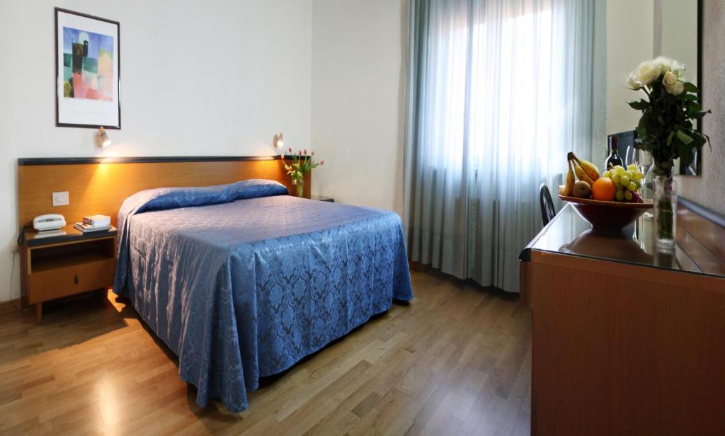 Postel nebo postele na pokoji v ubytování Hotel Nuova Grosseto
