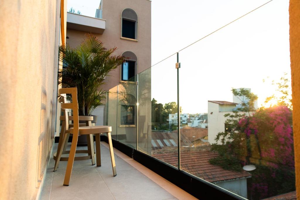 a balcony with a table and a chair on a balcony at Old Port Hotel in Limassol