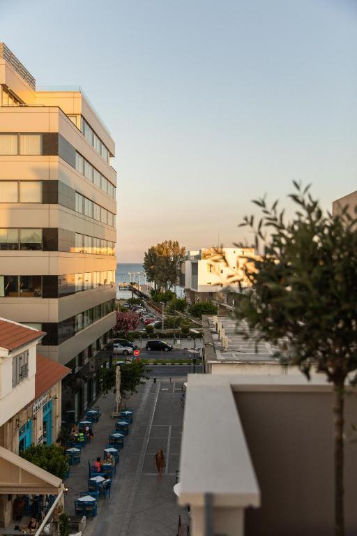 a city street with cars parked in a parking lot at Old Port Hotel in Limassol