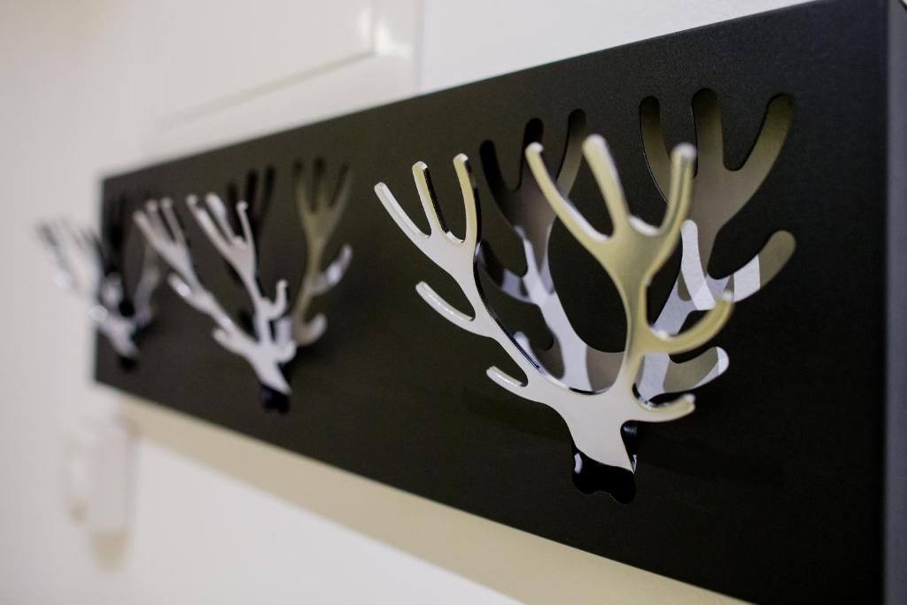 a shelf with three deer antlers on it at White House Bela Hiša in Ljubljana