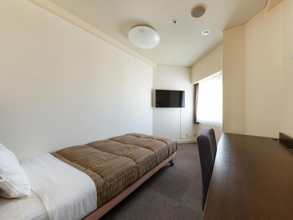 Postel nebo postele na pokoji v ubytování The OneFive Okayama