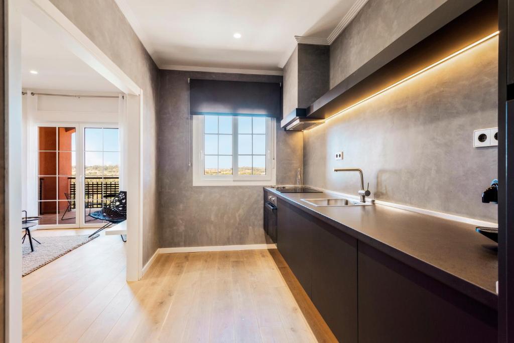 a kitchen with a sink and a counter top at Ama Islantilla Resort in Islantilla
