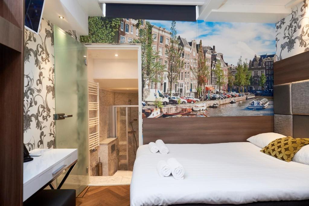 a bedroom with a view of a canal at The Townhouse Hotel in Amsterdam