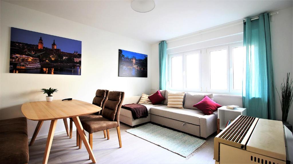 a living room with a couch and a table at central & lovely - for up to 6 persons in Würzburg